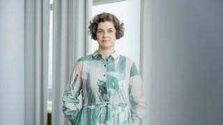 Chief Executive Officer of JHL, Mari Keturi, standing in front of a window.